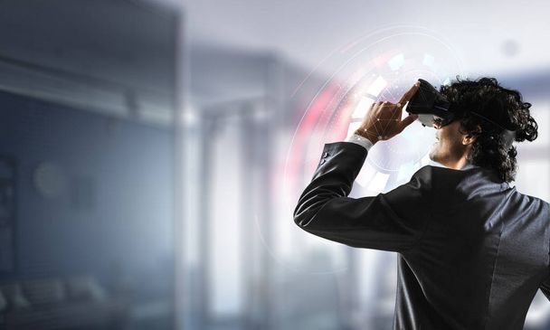 Businessman having VR experience. Mixed media - Фото, зображення