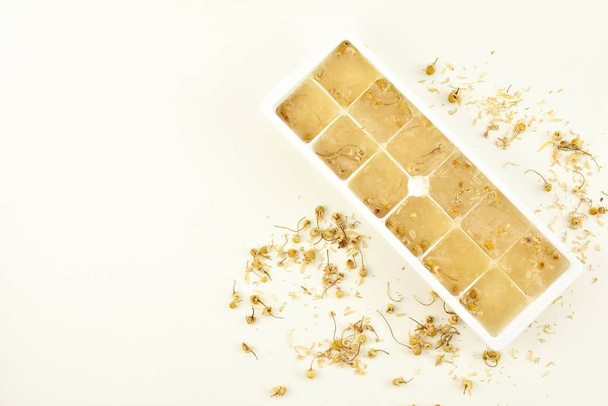 Chamomile ice cubes for skin treatment. - 写真・画像