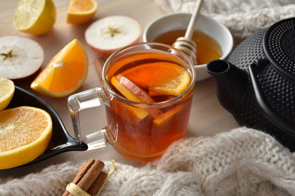 Warming aromatic Christmas tea with fresh apples, orange, lemon and cinnamon - Photo, Image