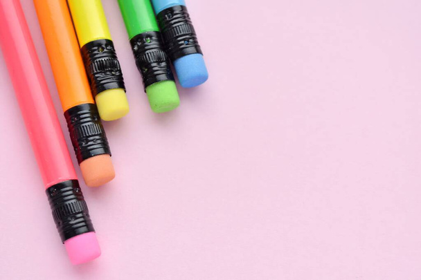 Colorful pencils with erasers on pink background, arts, back to school concept, top view, copy space. - Photo, image