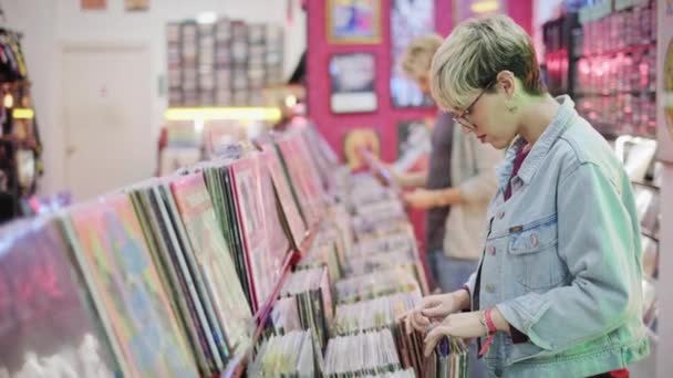 Young Woman Choosing Vintage Vinyl LP In Records Shop - Footage, Video