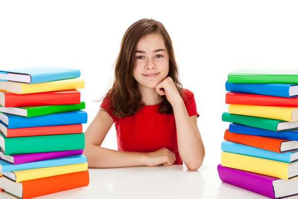Student sitting near pile of books - Φωτογραφία, εικόνα