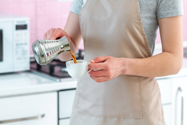 Barista in apron preparing hot tasty turkish coffee from cezve.  - Fotoğraf, Görsel