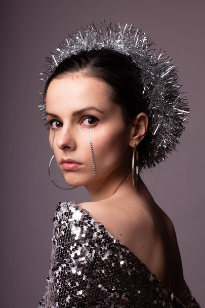 beautiful girl in a best-looking dress, a brilliant rim with rhinestones on her face - Fotoğraf, Görsel