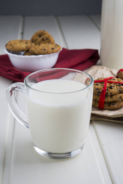 Very sweet retro bottle of milk with cookie on old table - Foto, imagen