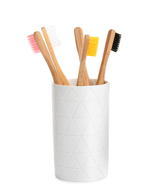 Bamboo toothbrushes in holder isolated on white - Foto, Imagem