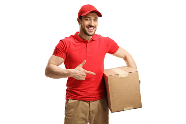 Delivery guy holding and pointing to a box  - Fotografie, Obrázek