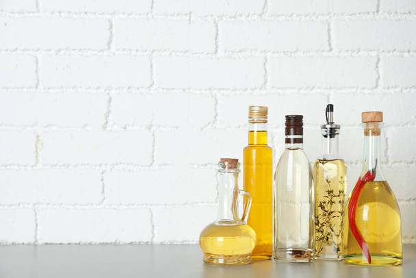 Different cooking oils on grey table. Space for text - Photo, image