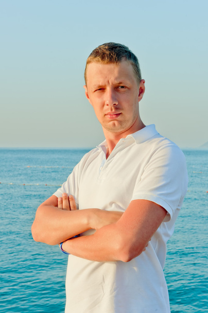 portrait of a man in a white shirt against the sea - Photo, Image