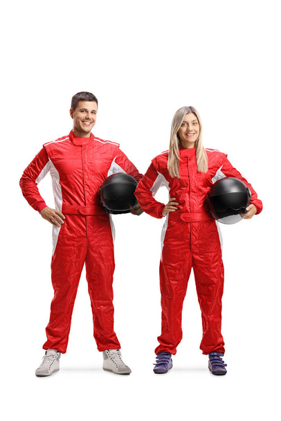Team of a male and female car racers holding helmet - Foto, afbeelding