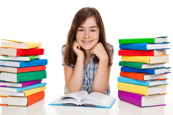 Student sitting near pile of books - Zdjęcie, obraz