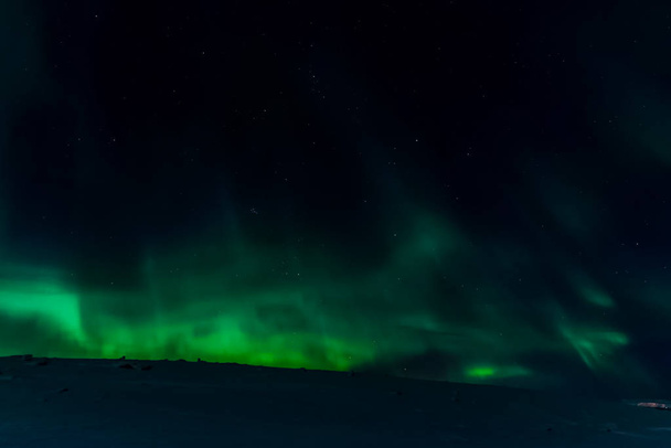 Aurora borealis in night northern sky. Ionization of air particl - Photo, Image