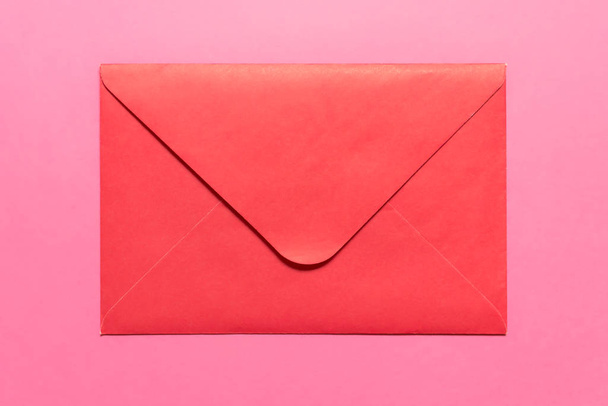 Closed pink envelope on pink backgound - Fotó, kép