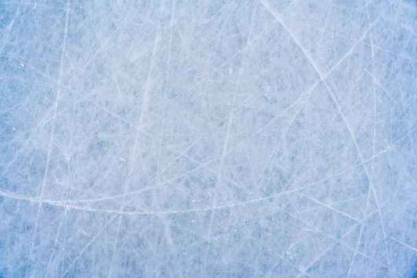 Ice background with marks from skating and hockey, blue texture of rink surface with scratches - Photo, Image