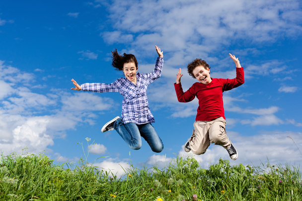 Girl and boy jumping - Foto, Imagen