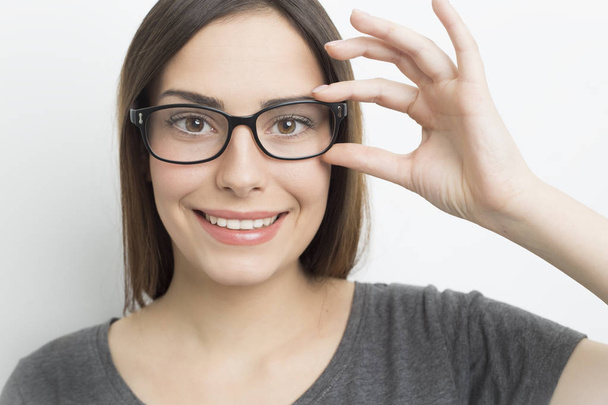 Smiling young woman in glasses on a white background.  - Photo, Image