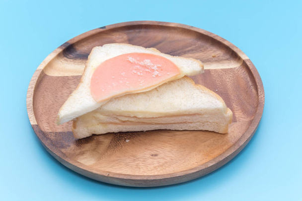 a piece of ham sandwich on blue background - Zdjęcie, obraz
