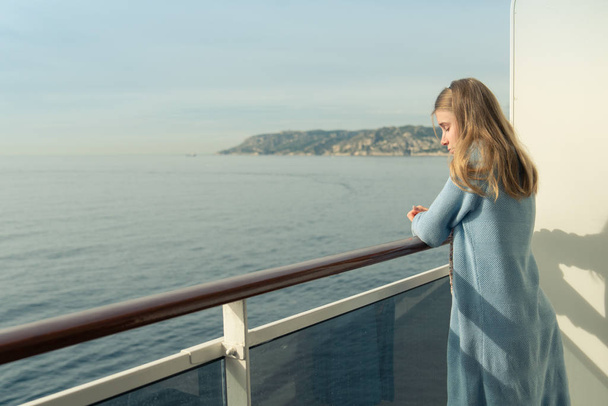 Cruise ship vacation. Teenager girl relaxing on luxury cruise ship balcony - Photo, image