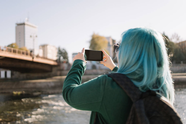 Woman making selfie while standing side river - Foto, Imagem