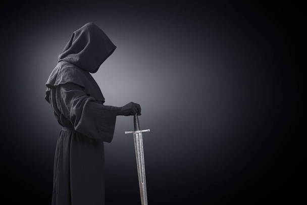 Ghostly figure with medieval sword in the dark - Фото, зображення