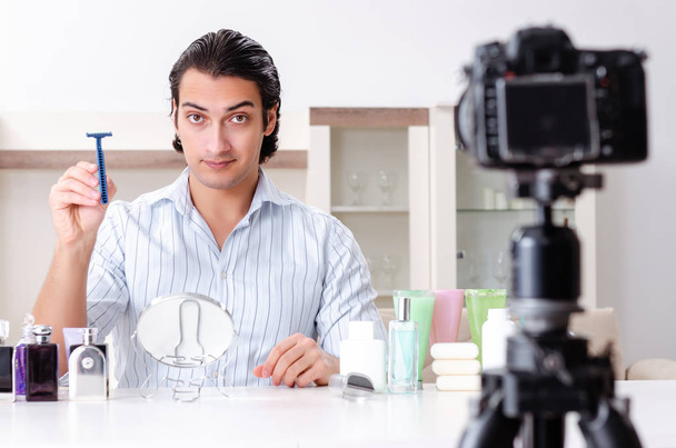 Young handsome man recording his blog in hygiene concept - Foto, Imagen