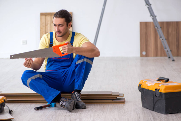 Young male contractor working indoors - Photo, Image
