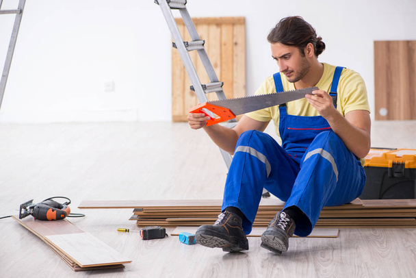 Young male contractor working indoors - Φωτογραφία, εικόνα