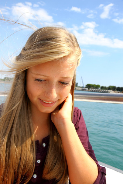 Cheerful young blonde girl on ship - Fotoğraf, Görsel