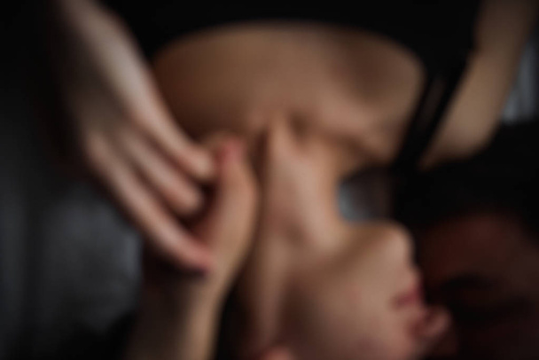 Defocused Top view of couple in love. Close-up portrait of the Lovers who lie on the bed at home, head to head. The morning of the newlyweds, tenderly resting on weekend at home. Concept of tactility - Foto, immagini