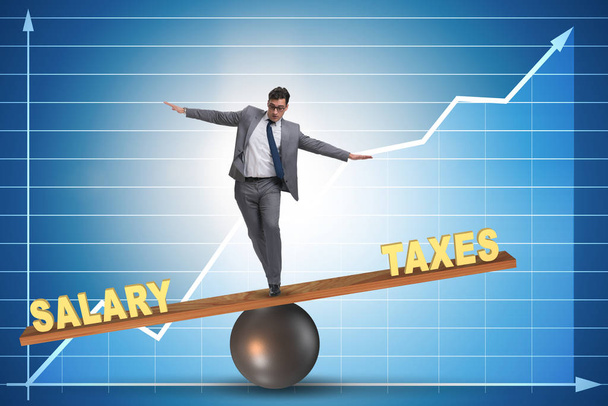 Businessman balancing between taxes and salary - Photo, Image