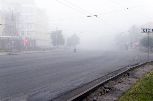 Komsomolskaya street and pension fund building on an early foggy morning. Translation: "STOP" - 写真・画像
