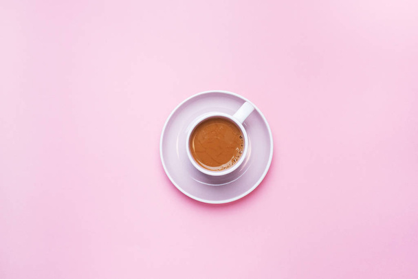 A Cup of coffee on a pink background with copy space. Top view. minimalism. - 写真・画像