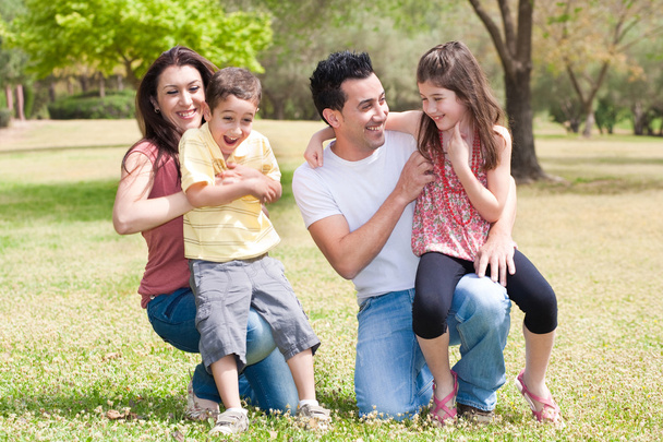 Happy family enjoying in a park - Фото, зображення