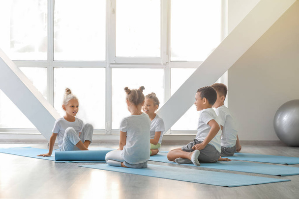 Little children practicing yoga in gym - Photo, image