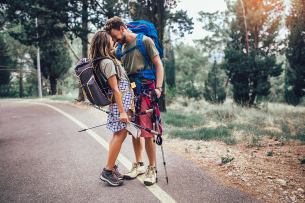 Romantic couple hiking on the path in mountains - Photo, Image