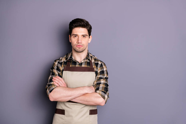 Photo of serious confident barista with arms crossed looking pensively at you near empty space isolated grey color background - 写真・画像