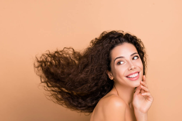Close up side profile photo beautiful she her lady look empty space touch facial skin show great result use shampoo hair cure recovery long wave hairdo flight wear no clothes isolated beige background - Photo, Image