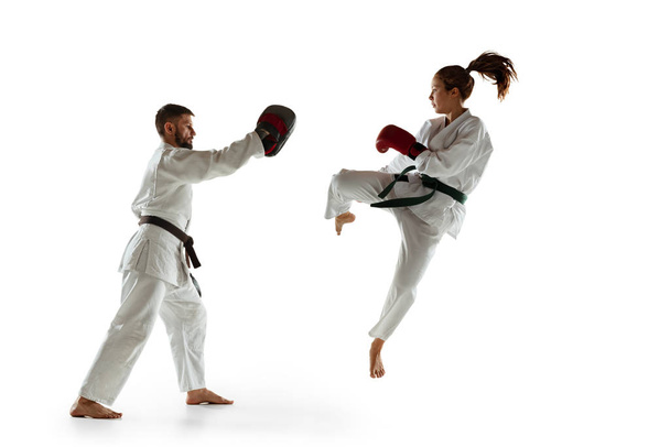 Junior in kimono practicing hand-to-hand combat with coach, martial arts - Φωτογραφία, εικόνα