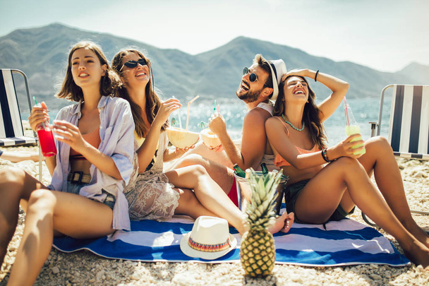 Beach party. Summer time. Young couples on vacation enjoying in  - Foto, imagen