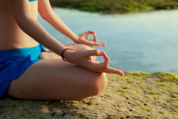 Styl życia jogi. Zamknij gyan mudra. Młoda kobieta medytująca, ćwicząca jogę i pranayama z gyan mudra na plaży, Bali - Zdjęcie, obraz