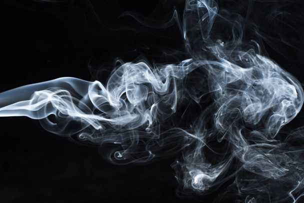 Photo of a wisp of smoke on a dark background - Foto, Imagen