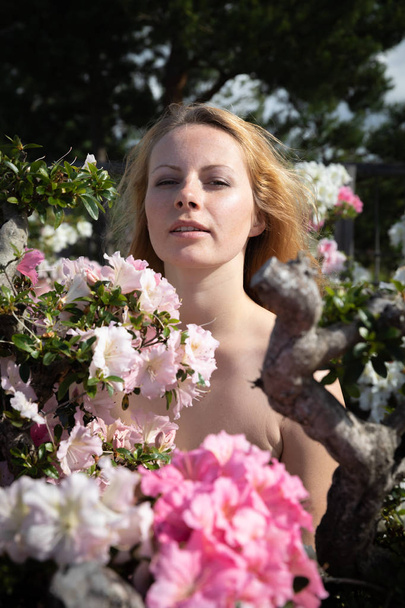 young woman among the flowers of azalea - Photo, Image
