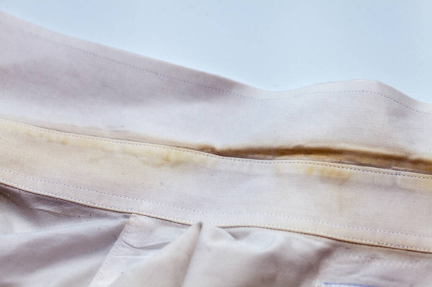 Yellow collar stain on white dirty shirt - Foto, Imagen