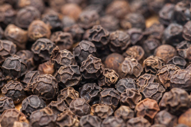 pile of Black Pepper on wooden plate - Photo, Image