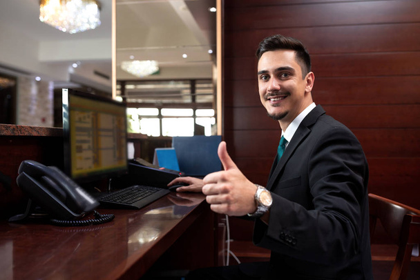 Hotel receptionist being happy with his job - Фото, изображение
