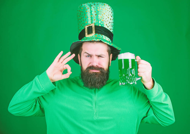 Patricks day party. Alcohol beverage. Symbol of Ireland. Man bearded hipster drink beer. Irish pub. Highly recommend. Drinking beer celebration. Fest and holiday menu. Dyed green traditional beer - Zdjęcie, obraz