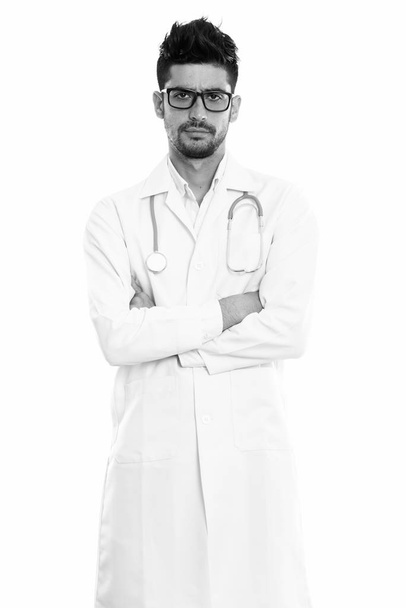 Studio shot of young Persian man doctor standing with arms crossed - Photo, Image