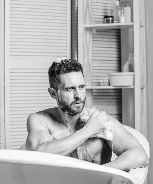 hygiene and health. Morning shower. man wash muscular body with foam sponge. macho man washing in bath. personal care. Sexy man in bathroom. desire and temptation. intimate hygiene - Foto, Imagen