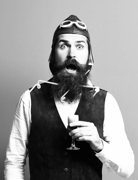 surprised handsome bearded pilot or aviator man with long beard - Foto, afbeelding