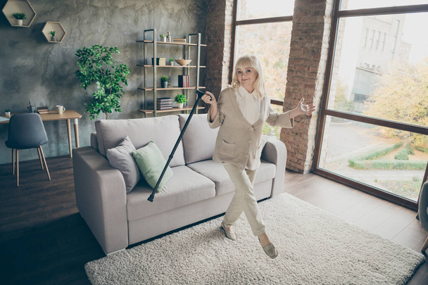 Full length body size view of her she nice attractive healthy lovely cheerful gray-haired granny dancing with cane having fun at industrial brick loft modern style interior house apartment - Fotoğraf, Görsel